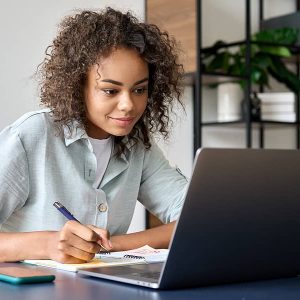 Women sitting in front of a laptop studing a self-paced CPA credits course