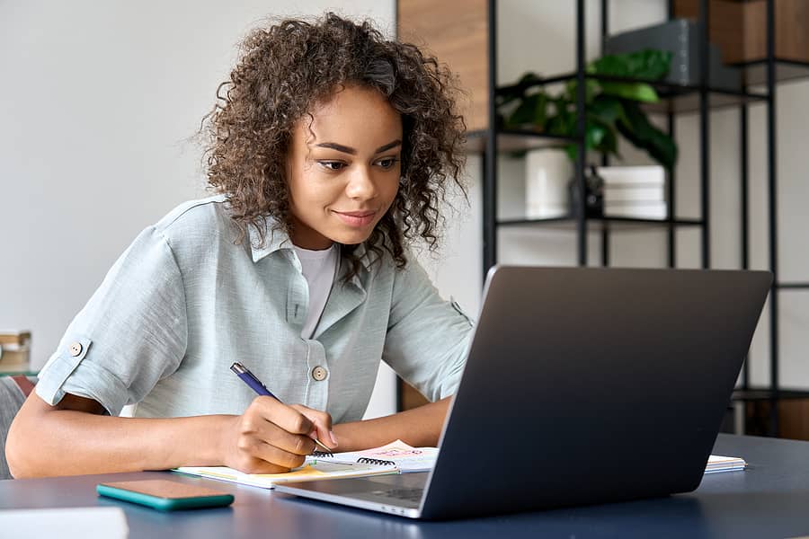Women sitting in front of a laptop studing a self-paced CPA credits course
